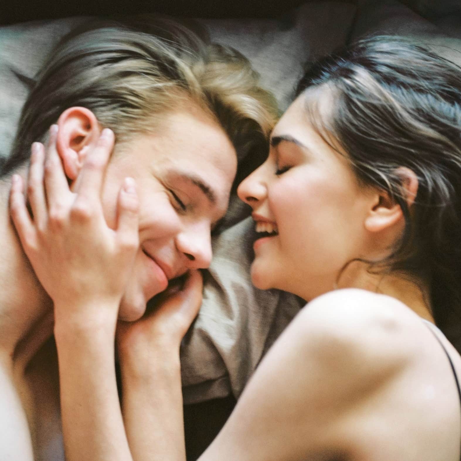 couple laughing in bed